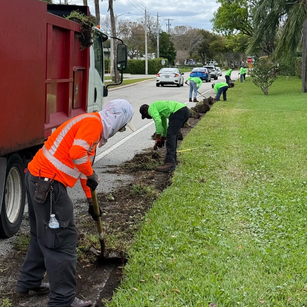 Schoen crew performing roadside edging and landscape maintenance in Palm Beach County